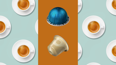 A blue Vertuo Nespresso capsule and a gold Original Nespresso capsule on an orange background over a background of cups of espresso shot from overhead.