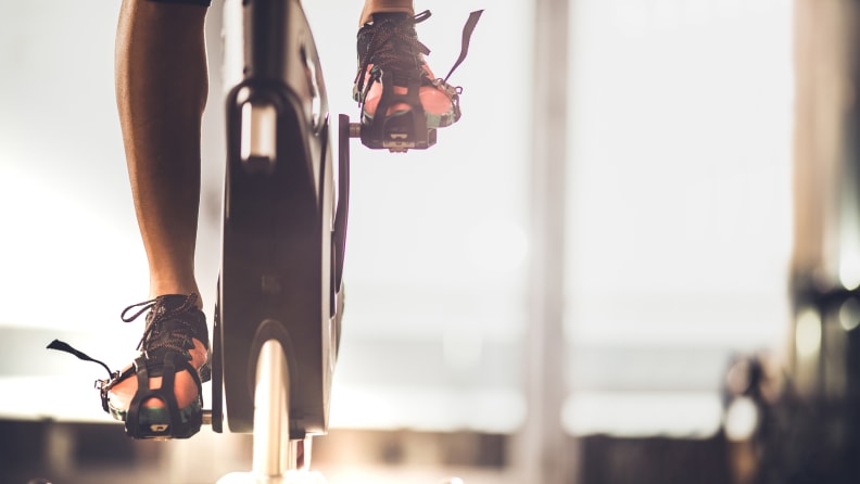 A woman using an exercise bike.