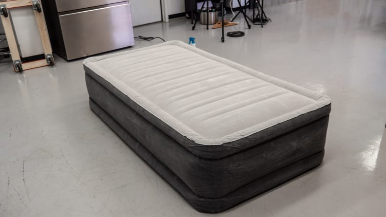 Patching inflatable mattress with tire patch kit. 