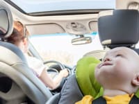 Boy in car seat riding in car