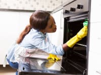 A woman cleaning her oven