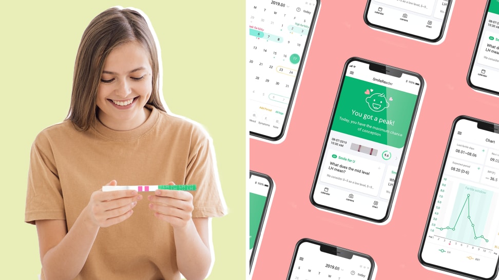 Person smiling at ovulation test strip next to smart phones displaying ovulation application.