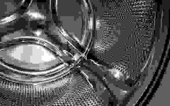 A close-up detail of a stainless steel washing machine drum