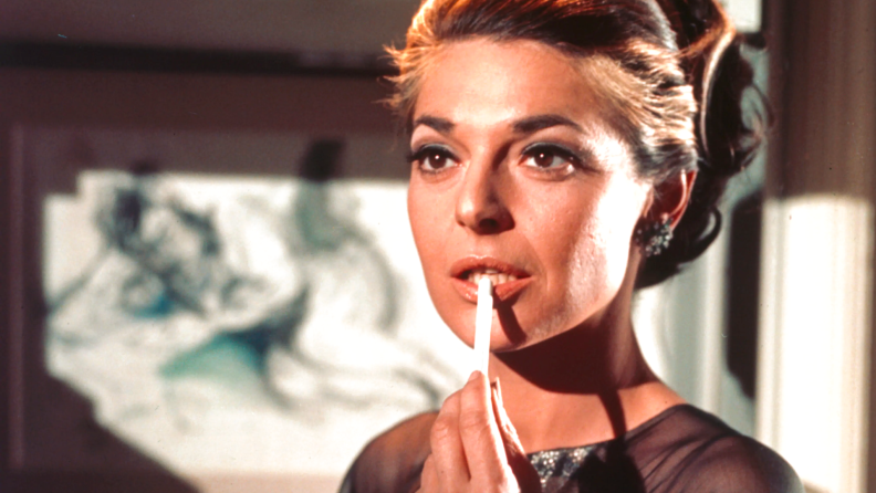 Actress Anne Bancroft readies a cigarette in a scene from The Graduate.