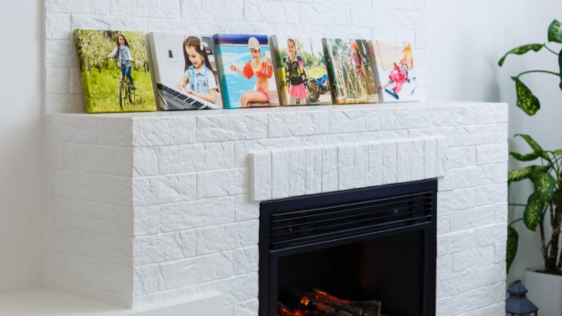Family photos stacked in a row on a mantel.