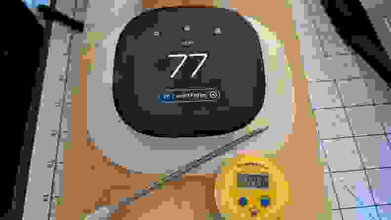 The Ecobee Enhanced thermostat appears with a thermometer in testing.