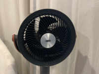 The black Dreo PolyFan Max S in a room with white curtains.