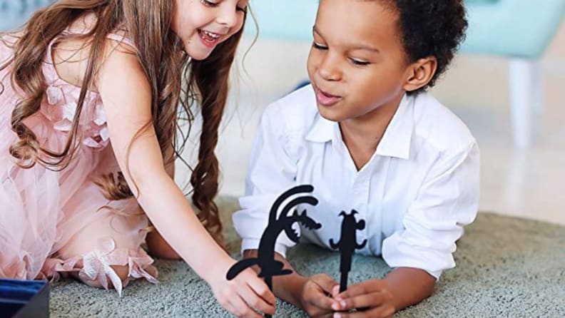 Two children with stick character toys together.