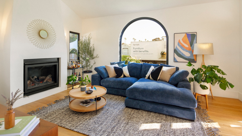 A living room with a picture window and a Fernish truck outside.