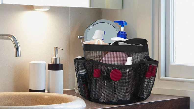 A mesh shower caddy sitting next to a sink.