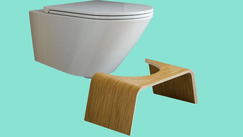 Wooden Squatty Potty in front of modern-looking toilet against teal background
