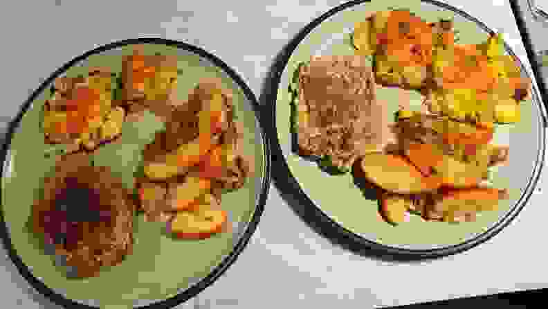 Two plates with porkchops, cooked apples and oven-roasted potatoes.
