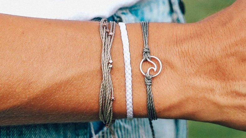 Close up of three bracelets on a wrist.