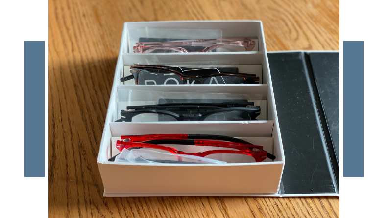 Box of sunglasses from Roka on top of wooden surfaces.