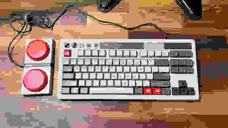 A grey retro keyboard with two large red buttons