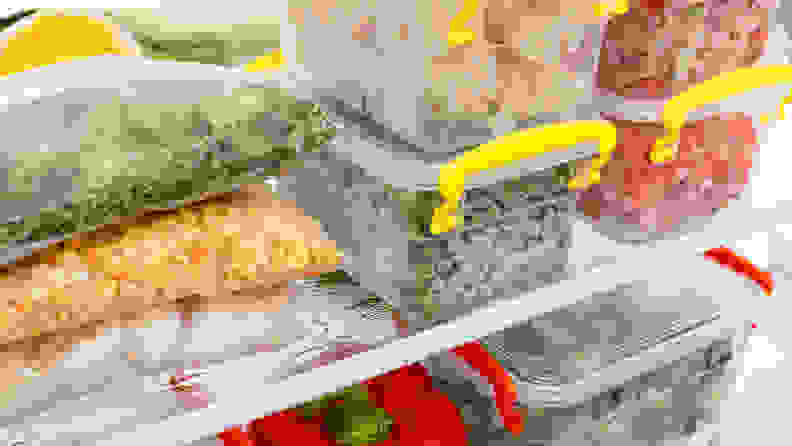 Clear containers of vegetables stacked up on refrigerator shelves.