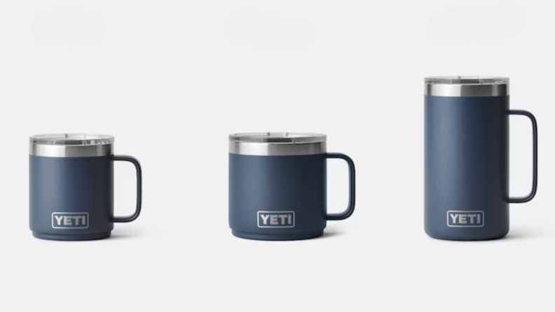 Three blue travel mugs with handles in a line