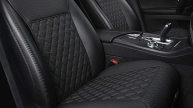 A pair of car seats are protected by faux-leather Black Panther seat covers.