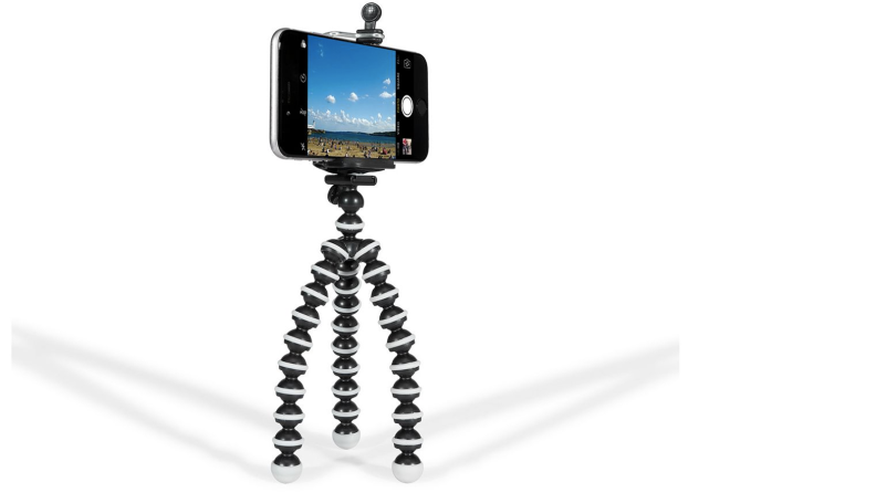 A phone held up in a small tripod with flexible legs