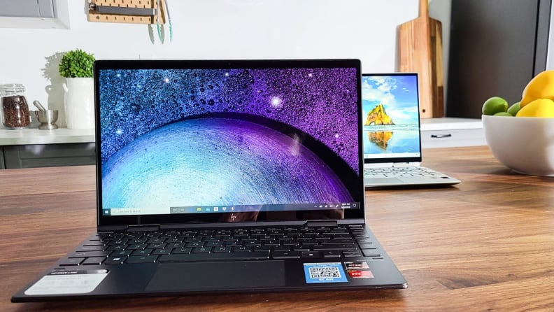 A laptop sits on a kitchen table.