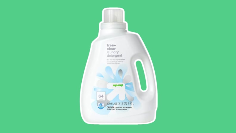 A bottle of Up and Up Free + Clear laundry detergent on a green background