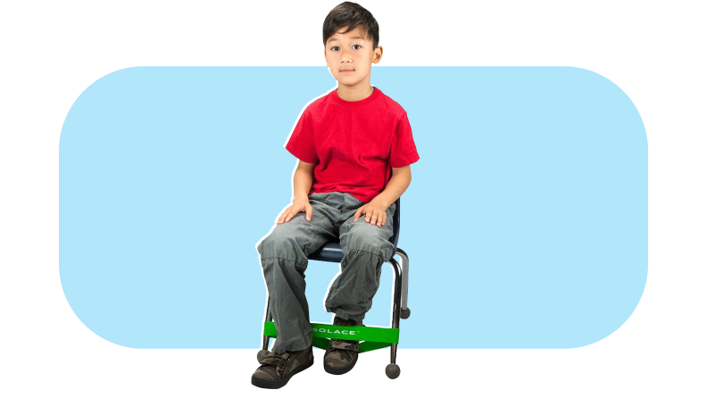 Small child sitting in chair while resting foot on green Kick Band.