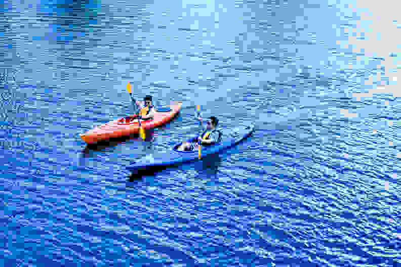 2 men kayaking in the Charles River.