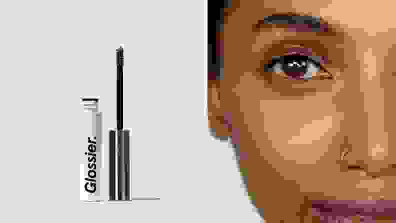 On the left: The Glossier Boy Brow tube stands on a gray background with the wand standing next to it. On the right: A closeup of a person's face after applying the Glossier Boy Brow to their eyebrows.