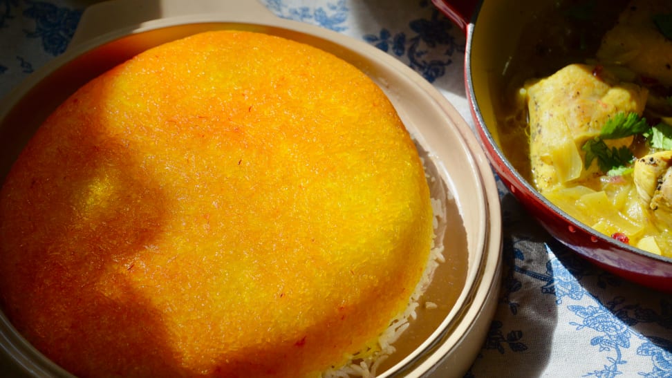 A plate of tahdig, a Persian rice dish with crispy bottom, is pictured right next to a pot of saffron chicken.