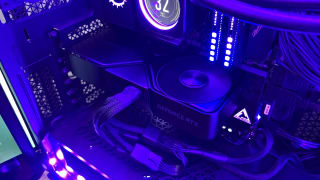 The Nvidia RTX 4070 Super installed with purple lighting glowing around the system.