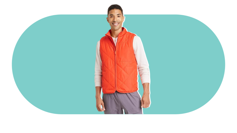 A male model wearing an orange puffer vest.