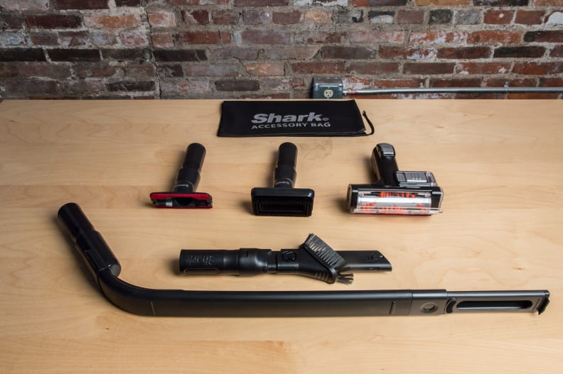 Curved tools, like the under appliance wand shown at the bottom, are used to get to hard-to-reach places.
