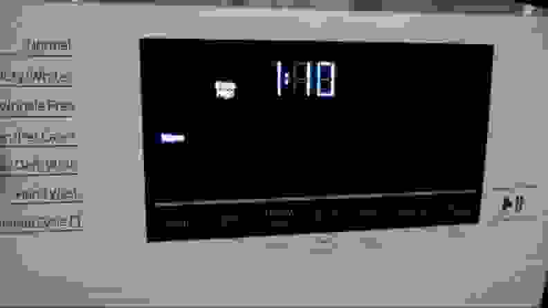 A black control screen on the washers top shows a time estimate and two selected features, lit up by LEDs.