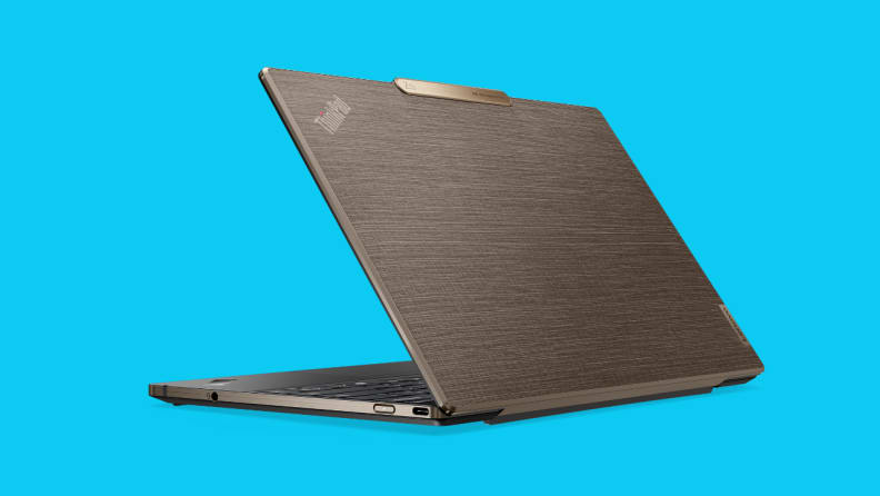 A Lenovo business laptop partially unfolded on a blue background.