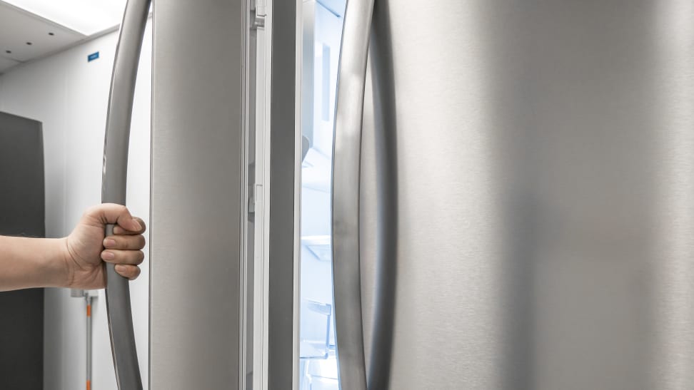 A refrigerator door held open to show the gasket.