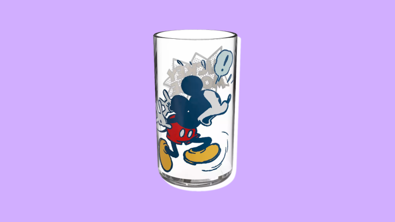 A drinking glass with a surprised looking Mickey against a purple background.
