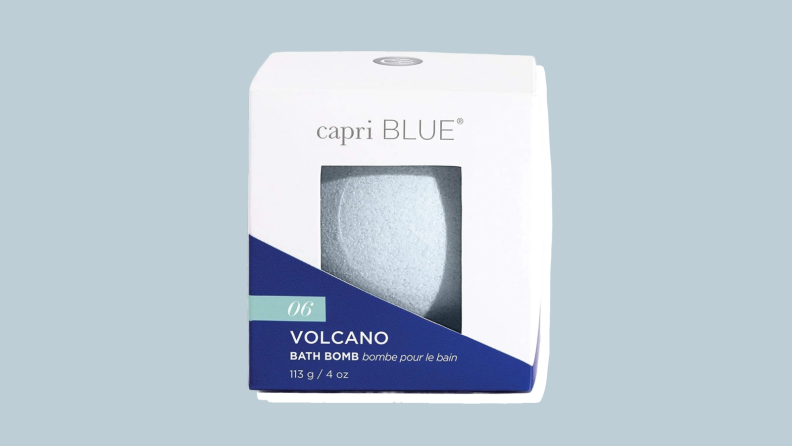 Capri Blue bath bomb against a grey-blue background.
