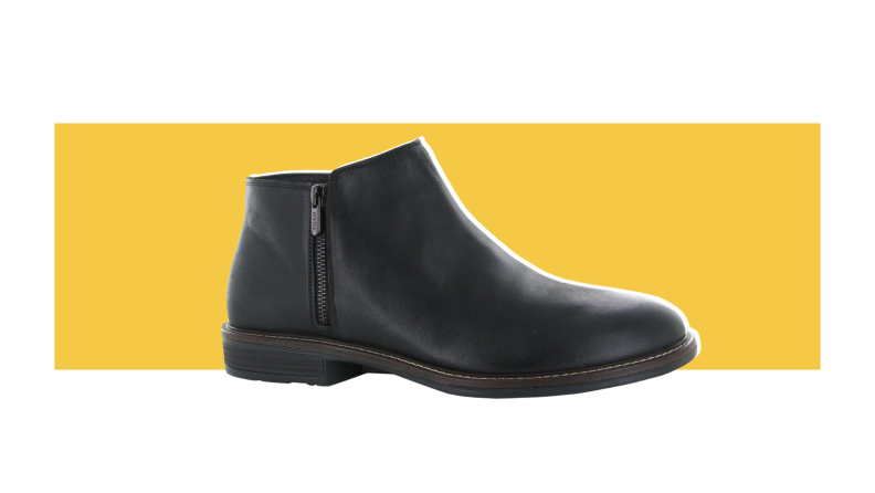 A black leather Chelsea boot with a zip-up closure.