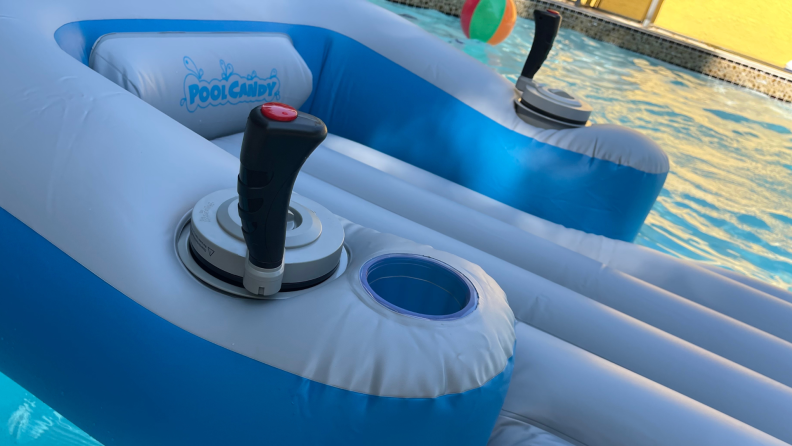 Close-up shot of the joysticks on the Sharper Image Motorized Pool Lounger floating on top of pool water.
