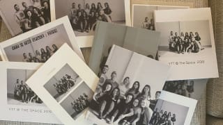 Several photo books strewn across a couch