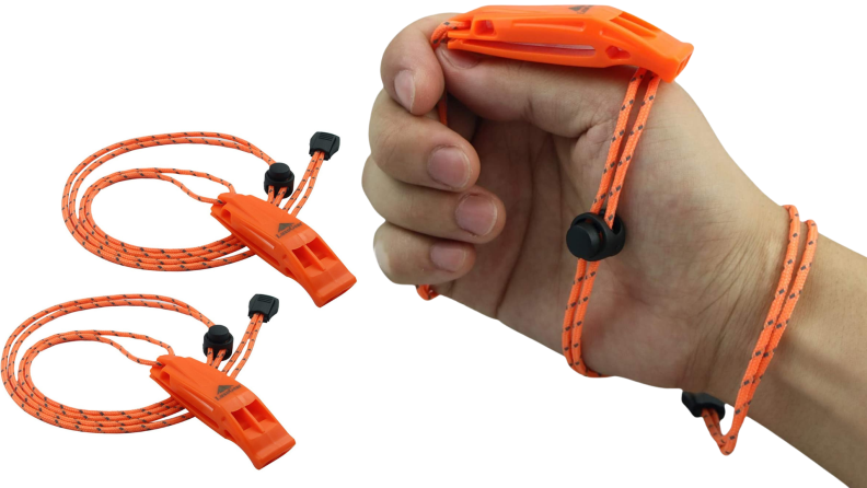 A person holds a bright orange emergency whistle.