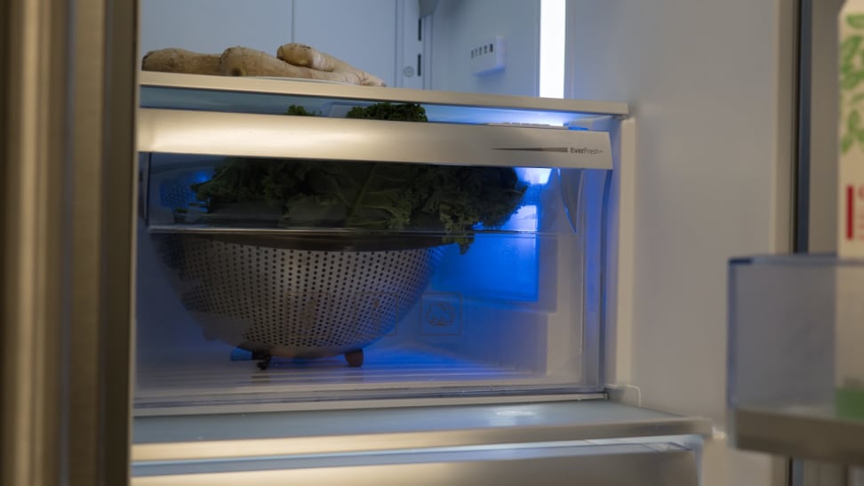 Produce on shelf in refrigerator.