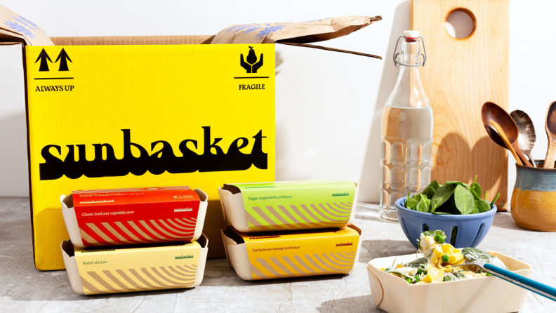 A Sunbasket box with prepared meals beside it
