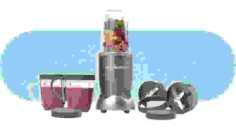 A filled NutriBullet NBR-1201 Blender next to two cups, with blended smoothies inside, and two blade attachments.