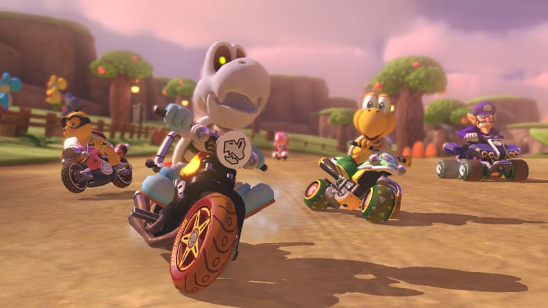A bunch of characters from the Mario franchise zoom by on motorcycles and go-karts.