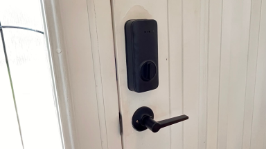 Close up of a door with a smart lock equipped.