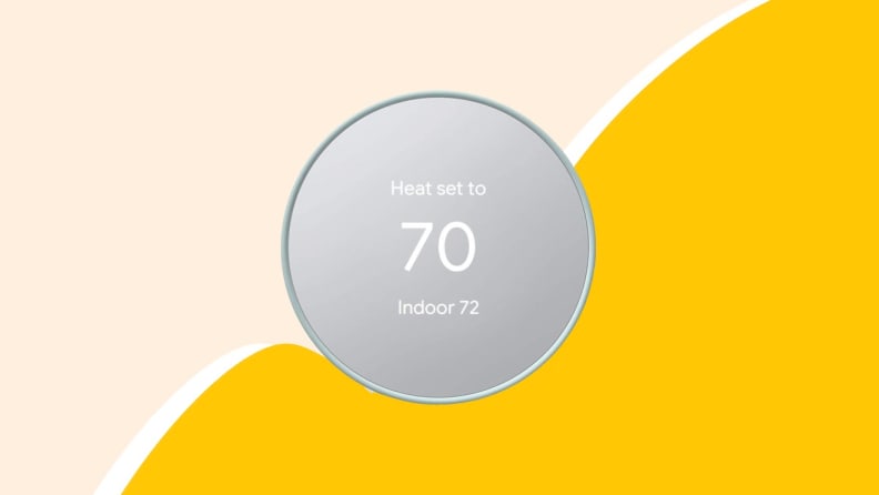 Silver smart thermostat on yellow background