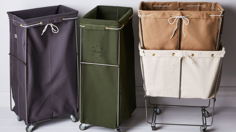 A line-up of laundry baskets made from steel frames and canvas bags