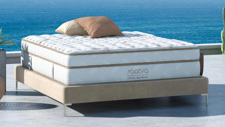 A Saatva mattress set up outside near the ocean.
