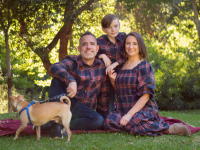 A family of three in Ivy City Co. plaid Madeline outfits in navy.